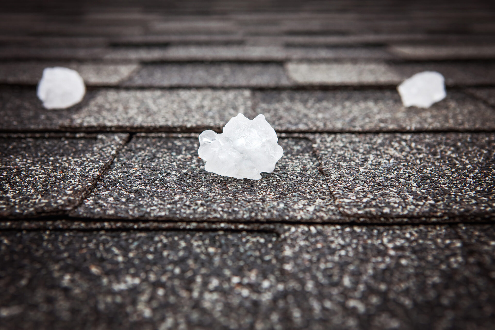 Chunks of ice on a roof. Ice on roof shingles.