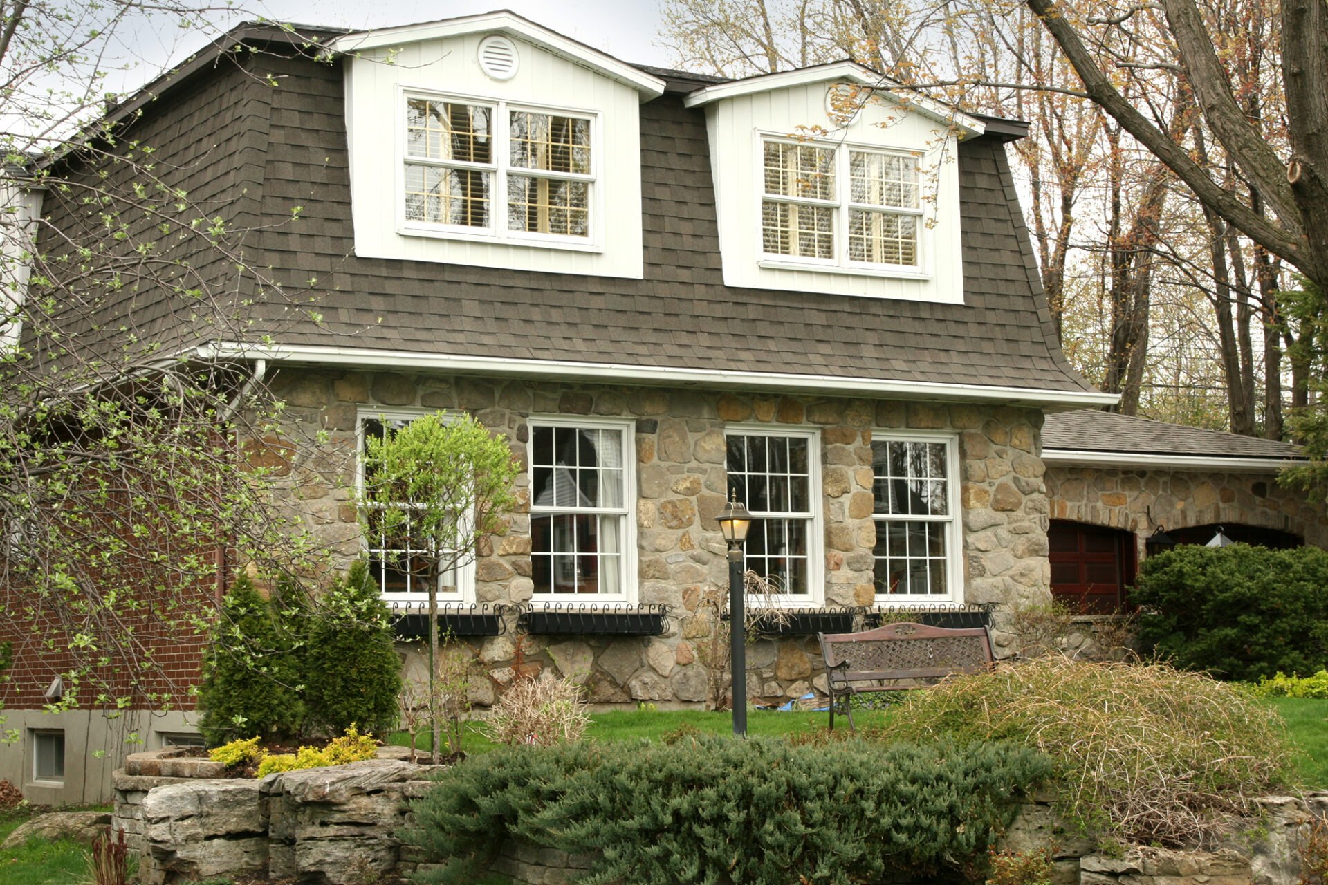 Two-story house with stone facade and dormer windows