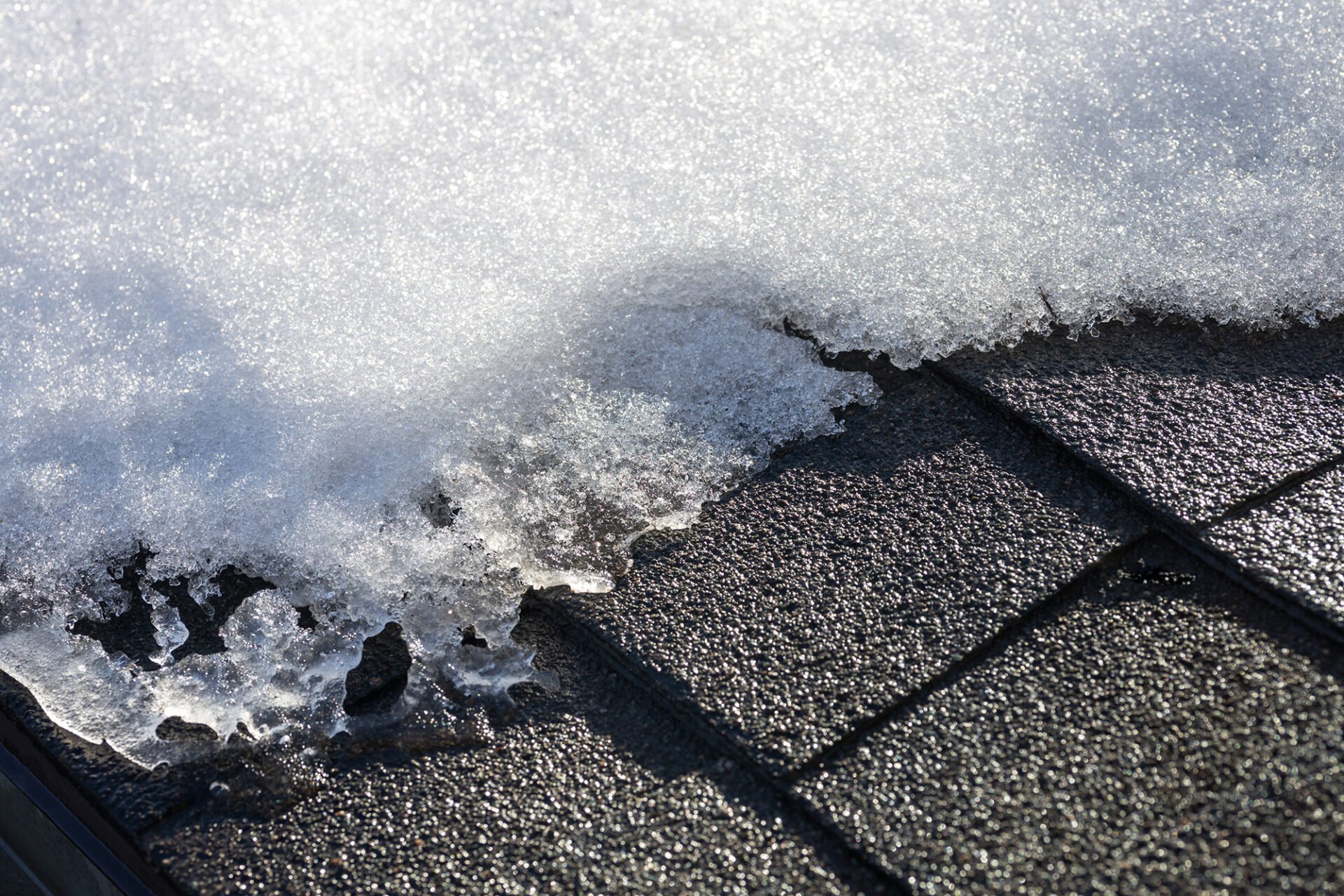 Snow melting on roof tiles. Close-up view.