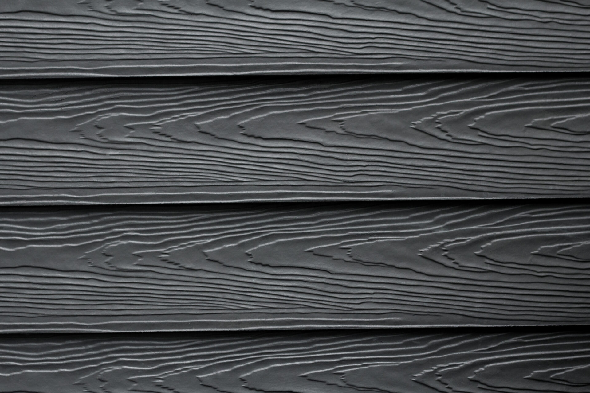 Dark grey wooden planks with a wood grain pattern. Horizontal planks
