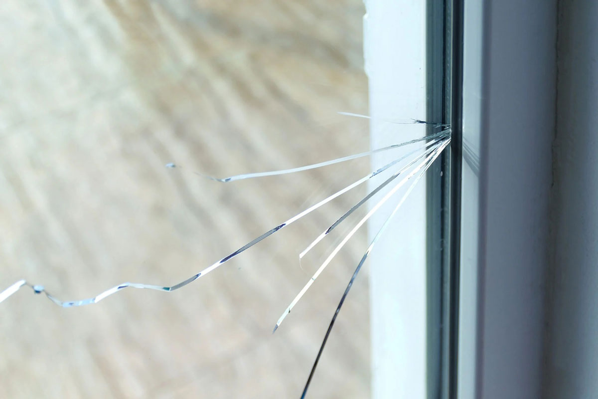 Broken Window Pane with Cracked Glass Close-up of a broken window with cracked glass.