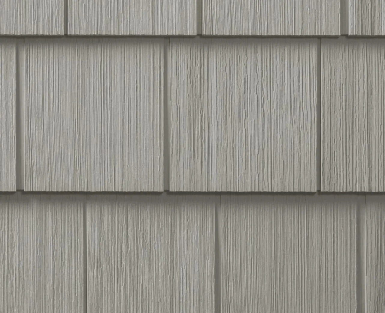 Gray Shingle Siding on a Building Exterior Gray shingle siding with wood texture. Exterior building material.