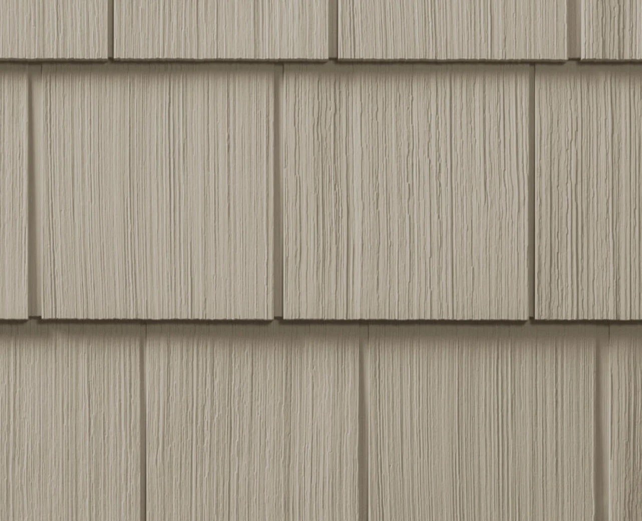 Close-up of gray siding shingles on a building Gray siding shingles. Exterior wall covering.