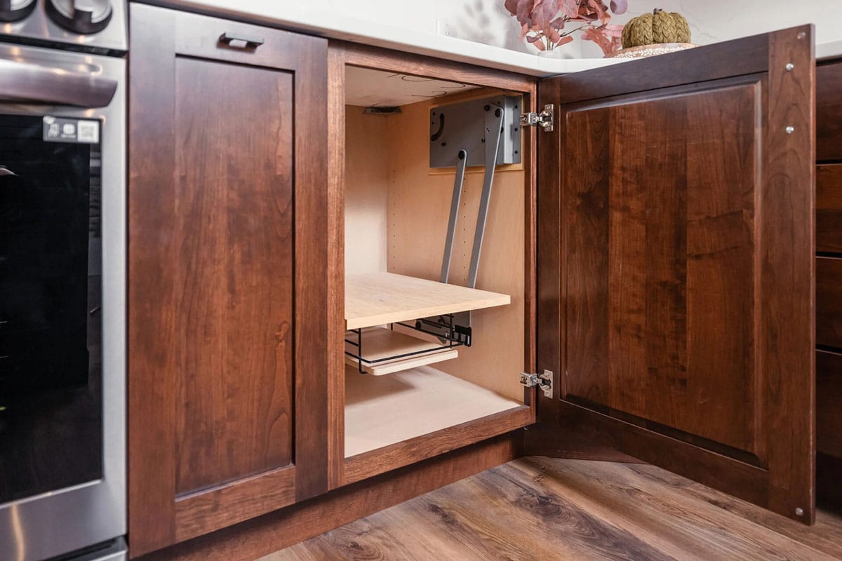 Dark brown kitchen cabinet with pull out shelves.