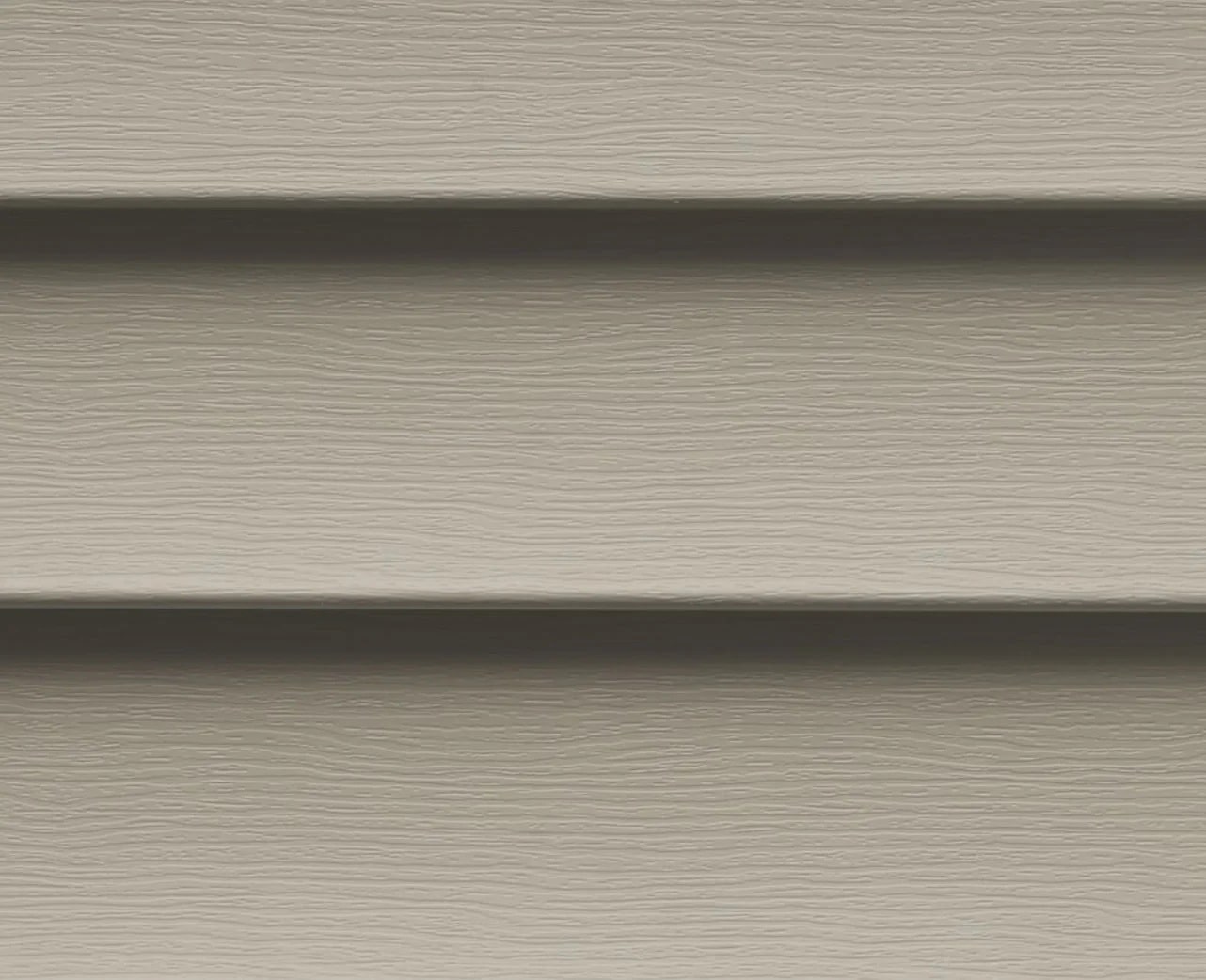 Taupe vinyl siding panels. Horizontal closeup view.
