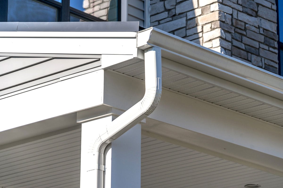 A white gutter system on a house.