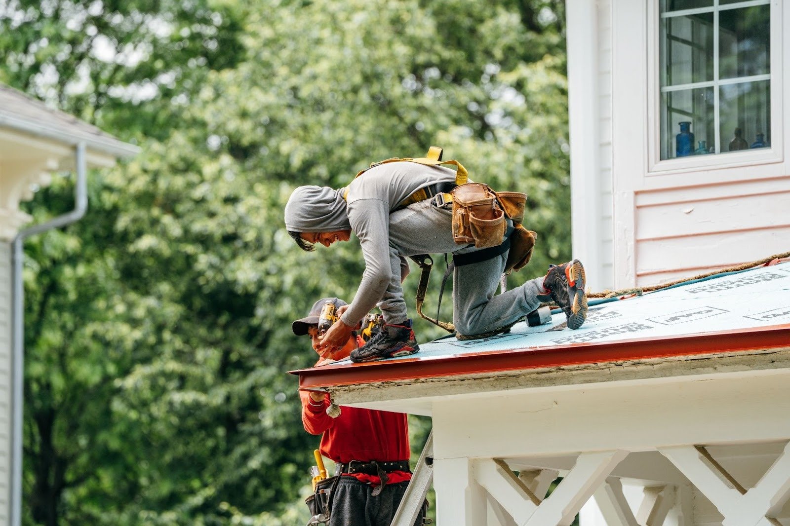 Two men working on a roof