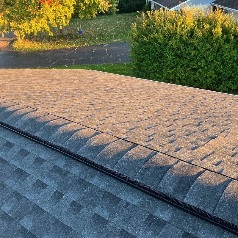 Close-up of a gray shingled roof with black trim Gray roof shingles with black edge trim. Residential roof.