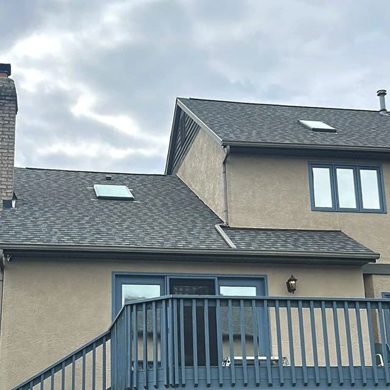 A house with a grey roof and blue trim