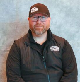 a man in a black jacket and hat