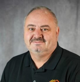 man in black shirt. He is smiling.