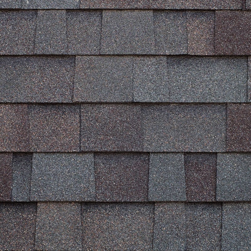 Close-up of gray and brown roof shingles Gray and brown roof shingles. Roofing material texture