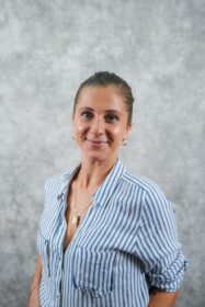 A woman wearing a blue and white striped shirt
